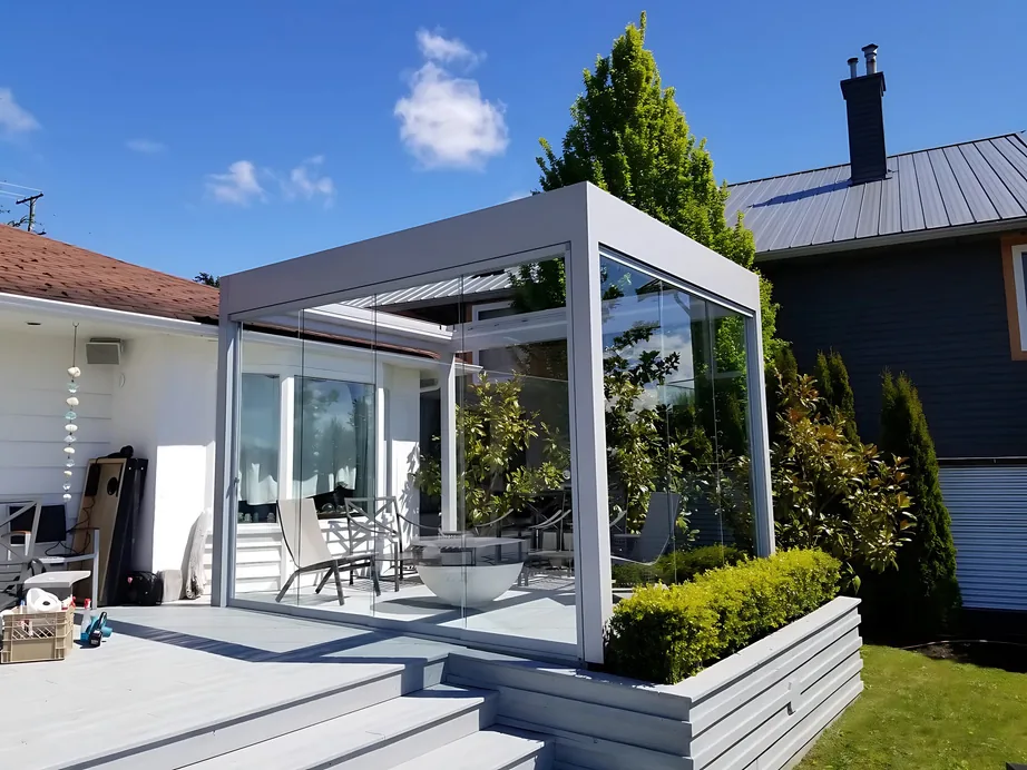 Frameless sliding glass enclosure on a backyard deck