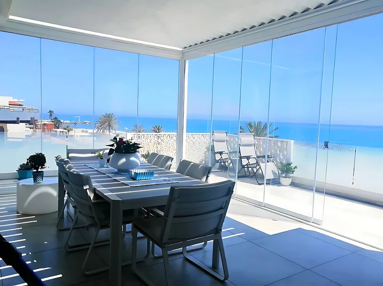 Oceanview frameless sliding glass outdoor enclosure by Luxe Pergola