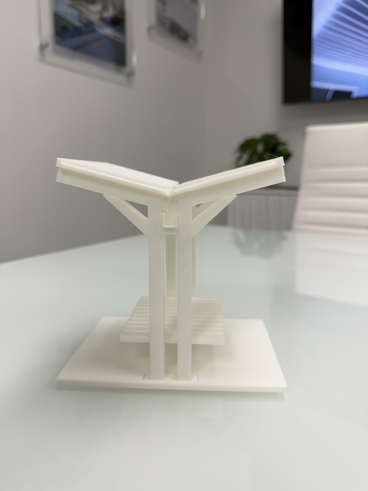 Scale prototype of the Tequesta Butterfly TB.2B court bench, with a valley roof whose concealed gutter drains through the posts so neither court takes a drip line.