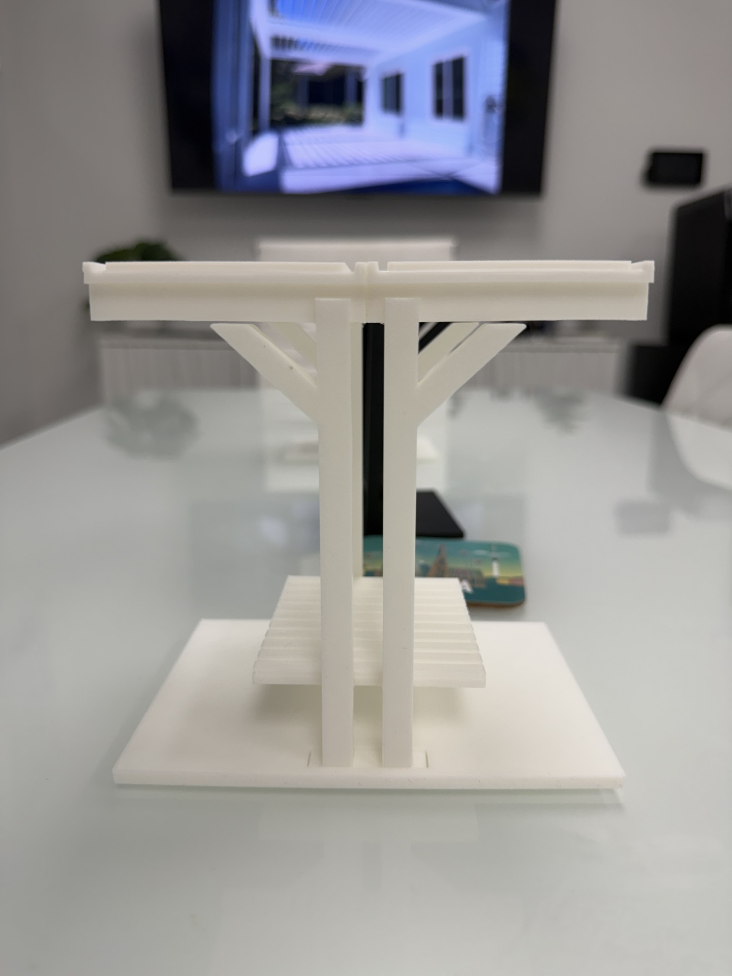 Scale prototype of the Tequesta Flat TB.2F, a double-sided court bench that serves two courts at once with a continuous sit, shelf and sit deck.