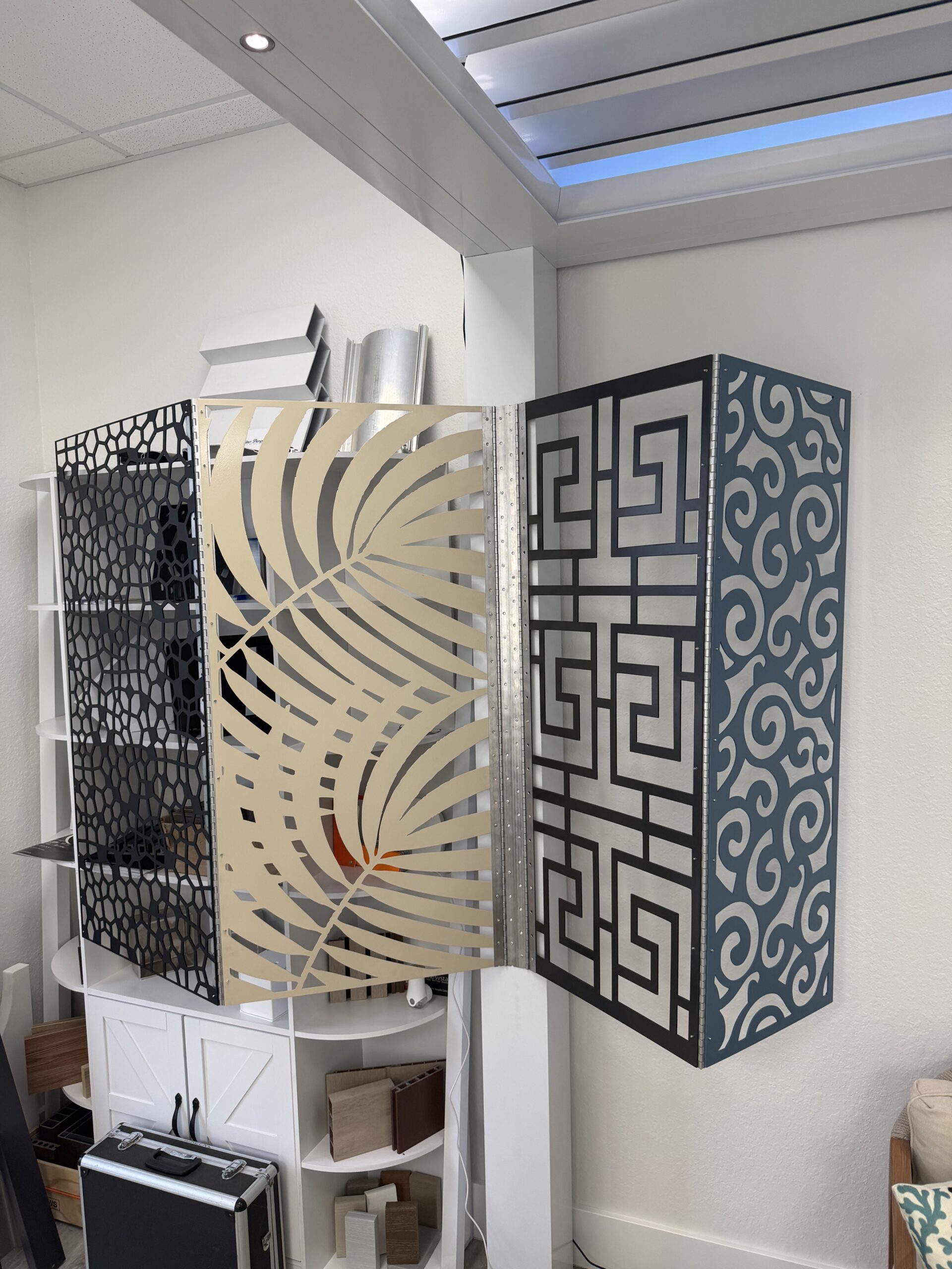 Custom water-jet cut aluminum privacy screen panel used courtside as a wind block, backdrop and branded partition.